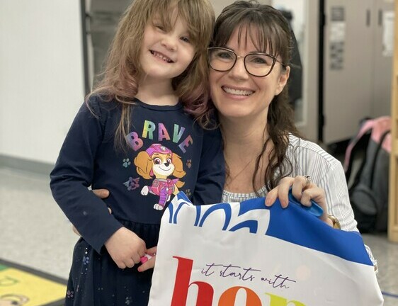 Principal Jody Centazzo presents Willow Herrington from Care to Learn Preschool at Duclos School with her prize.